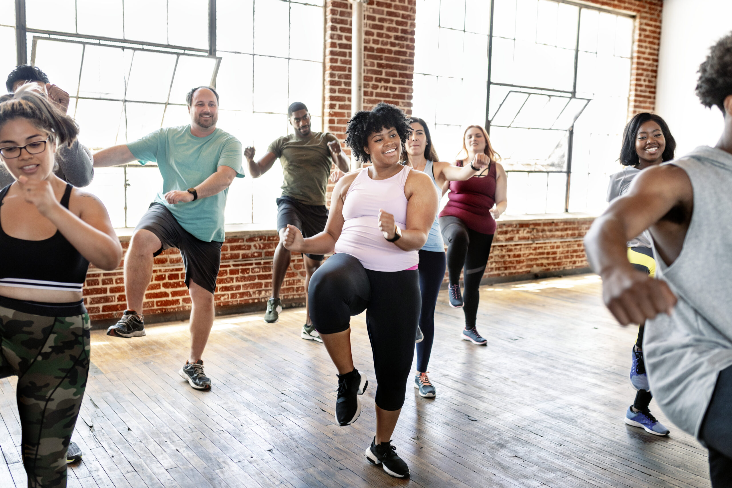 diverse people in an active dance class